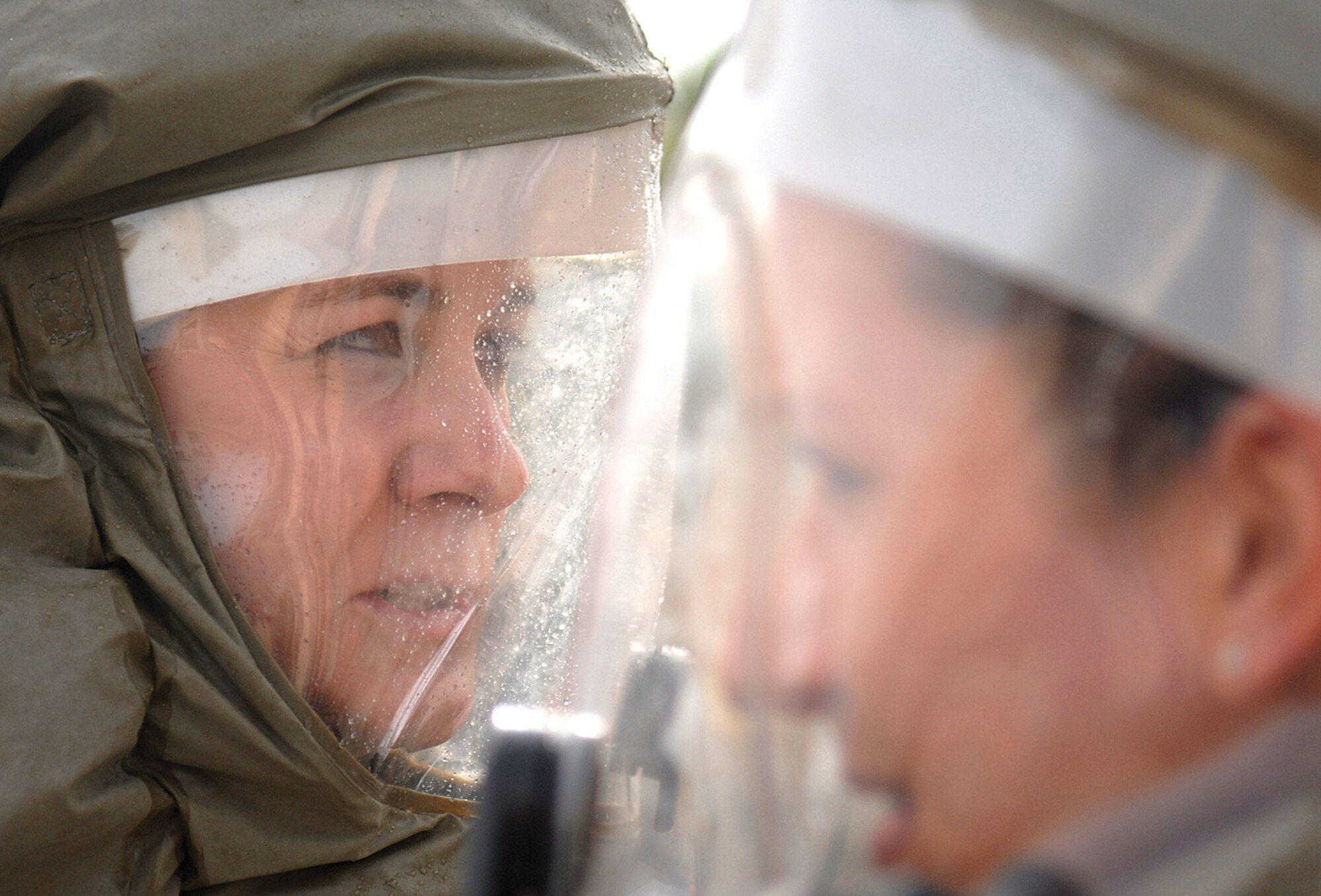 Tech. Sgt. Jennifer Medved, 56th Dental Squadron dental lab technician, discusses decontamination procedures with other medical staff during a major accident response exercise Tuesday on the east side of the medical clinic.  (U.S. Air Force photo/Airman 1st Class Sandra Welch.)