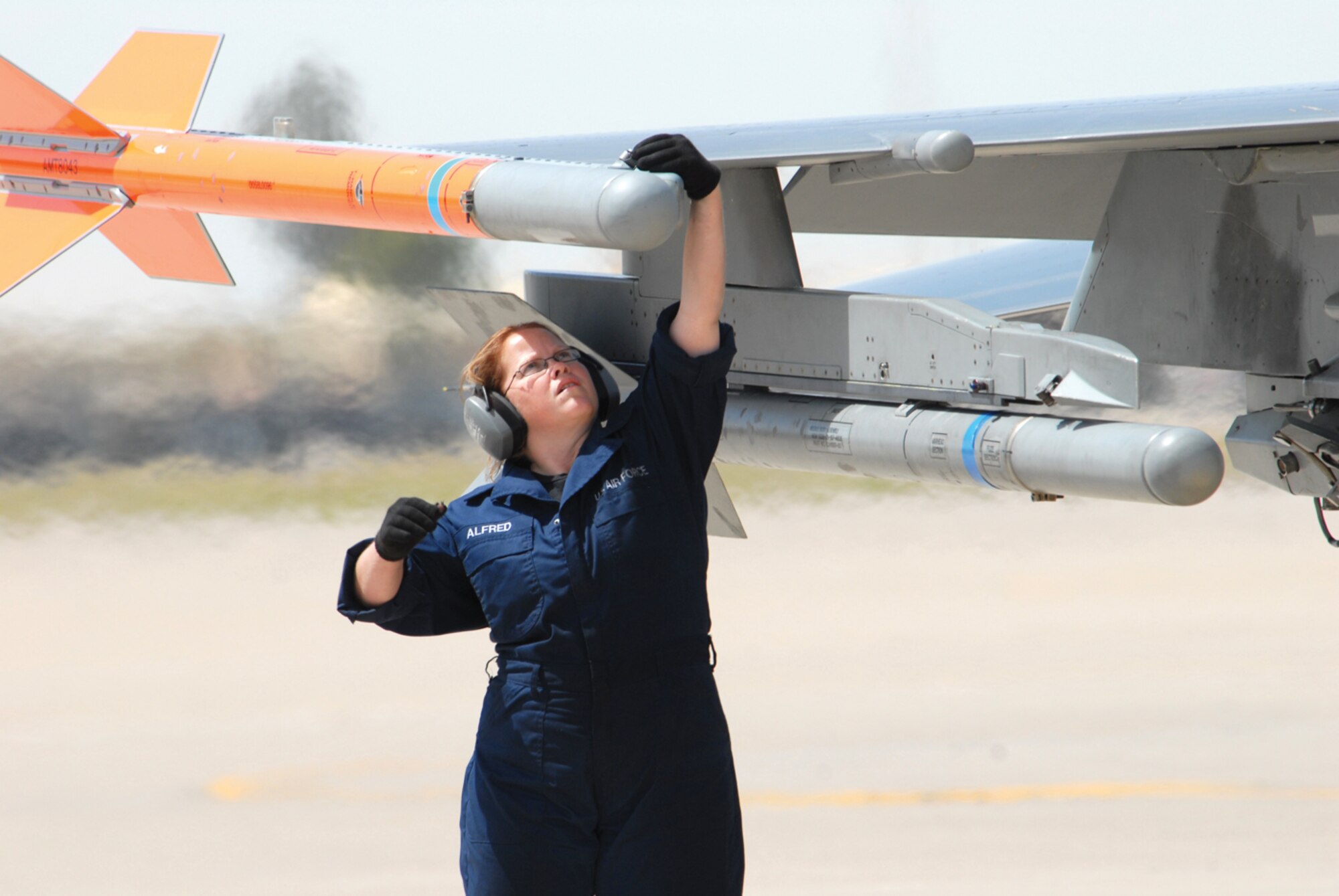 Staff Sgt. Catherine Alfred, 56th Maintenance Operations Squadron end-of-runway team leader, does an end-of-runway inspection by the book on an F-16 fighting Falcon April 30. (U.S. Air Force photo/ Debbie Silliman Wolfe)