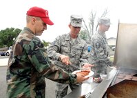 From left to right, Master Sergeant John Gaskill, member of the 60th Civil Engineer Squadron, Master Sergeant Jeffery Needham, member of the 60th Force Support Squadron and Brent Hardsaw, member  of the 60th Civil Engineer Squadron, prepare a free barbeque  lunch for airman and their families during Airman Preparedness day at Travis Air Force Base May 1, 2009. (U.S. Air Force photo by Civ/Amanda Lopez)