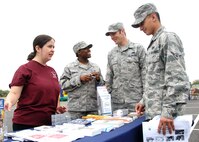 From left to right, Erin Greenwell, Health Education Program Manager and member of the 60th Aerospace Medicine Squadron, and Senior Airman Shaton Kennedy, Diet Technician and member of the 60th Medical Diagnostic and Therapeutic Squadron, provide information about the Health and Wellness Center at Travis Air Force Base to Senior Airman Robert Hunt, member of the 60th Aerial Port Squadron, and Airman Jesse Rivera, member of the 660th Aircraft Maintenance Squadron during Airman Preparedness day May 1, 2008. HAWC took part in the event to promote the importance of healthy living and fitness to the Air Force Mission. (U.S. Air Force photo by Civ/Amanda Lopez)