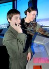 Assisted by Senior Airman Dana Reed, member of the 60th Operation Support Squadron, 12 year old Nicholas Gebhardt gets a chance to talk on the radio to an aircrew from the Air Traffic Control Tower at Travis Air Force Base as part of the Pilot for a day Program April 16th, 2009. The program was created to provide wish-fulfillment opportunities to children who have faced or are facing life threatening illnesses. (U.S. Air Force photo by Civ/Diane DeRemer)
