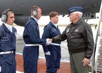 While visiting Travis Air Force Base, from right to left, General Arthur Lichte, Air Mobility Command Commander meets Technical Sergeant Daniel Butler, Staff Sergeant Jason Rictor and Airman First Class Thomas Shook, all three are members of the 60th Aerial Port Squadron and are part of the Elite Staircase Support Team .  Gen Lichte presented an Air Mobility Command coin to each of the airmen. (U.S. Air Force photo by Civ/Nan Wylie)
