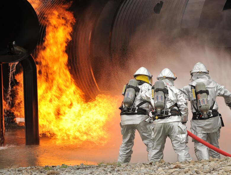 Firefighters attack the flames of a simulated aircraft fire during a joint training exercise May 4 at Offutt Air Force Base, Neb. Firefighters from active-duty, Air Guard and Reserve units participated in the joint training exercise for disaster preparation. (U.S. Air Force photo/Charles Haymond)