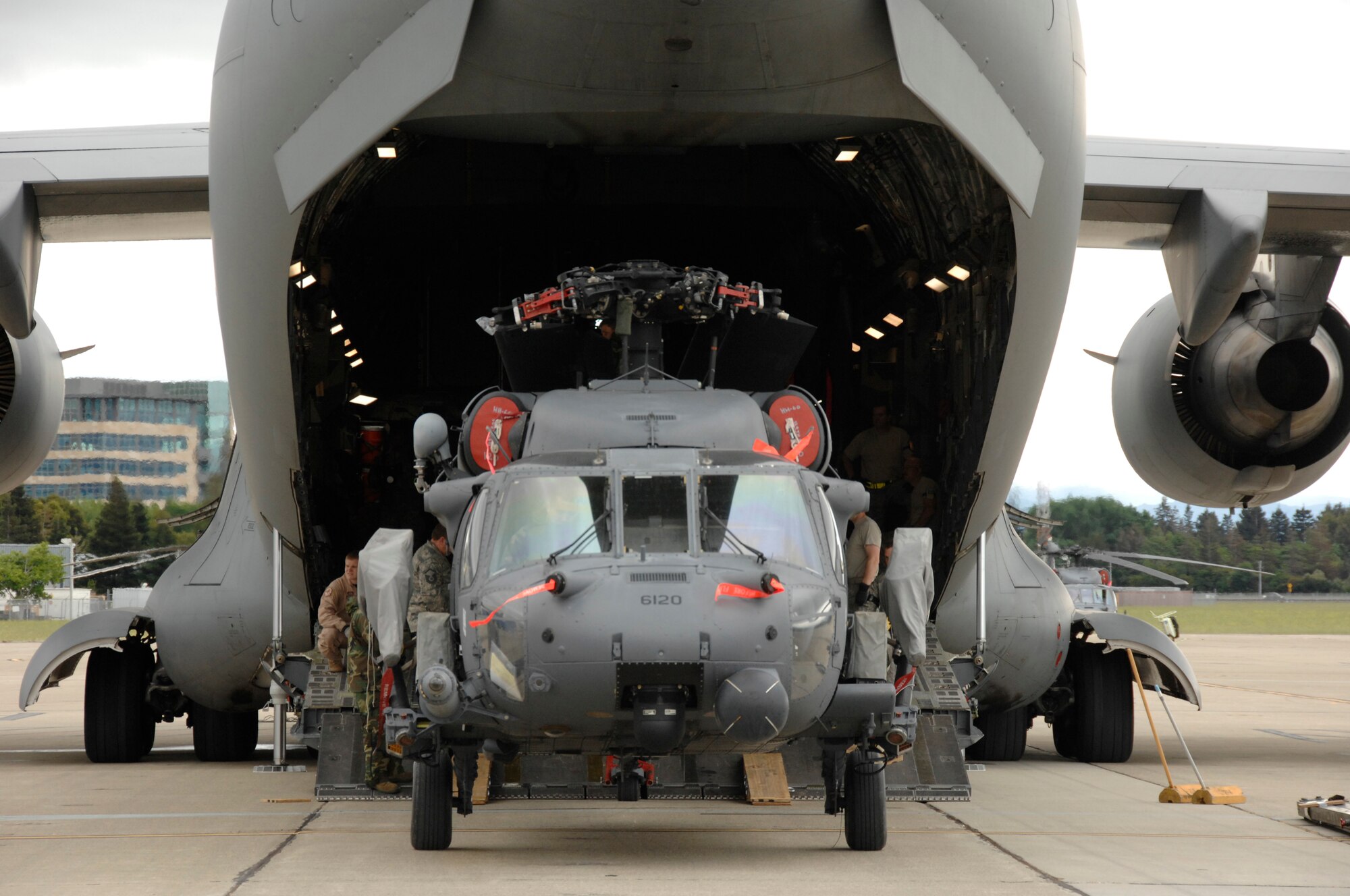 An HH-60G Pave Hawk rescue helicopter from the 129th Rescue Wing, Moffett Federal Airfield, Calif., is prepped for loading in a C-17 Globemaster.  More than 50 Airmen and three Pave Hawks from the 129th Rescue Wing deployed to Afghanistan May 3, 2009. (U.S. Air Force photo by Master Sgt. Dan Kacir)