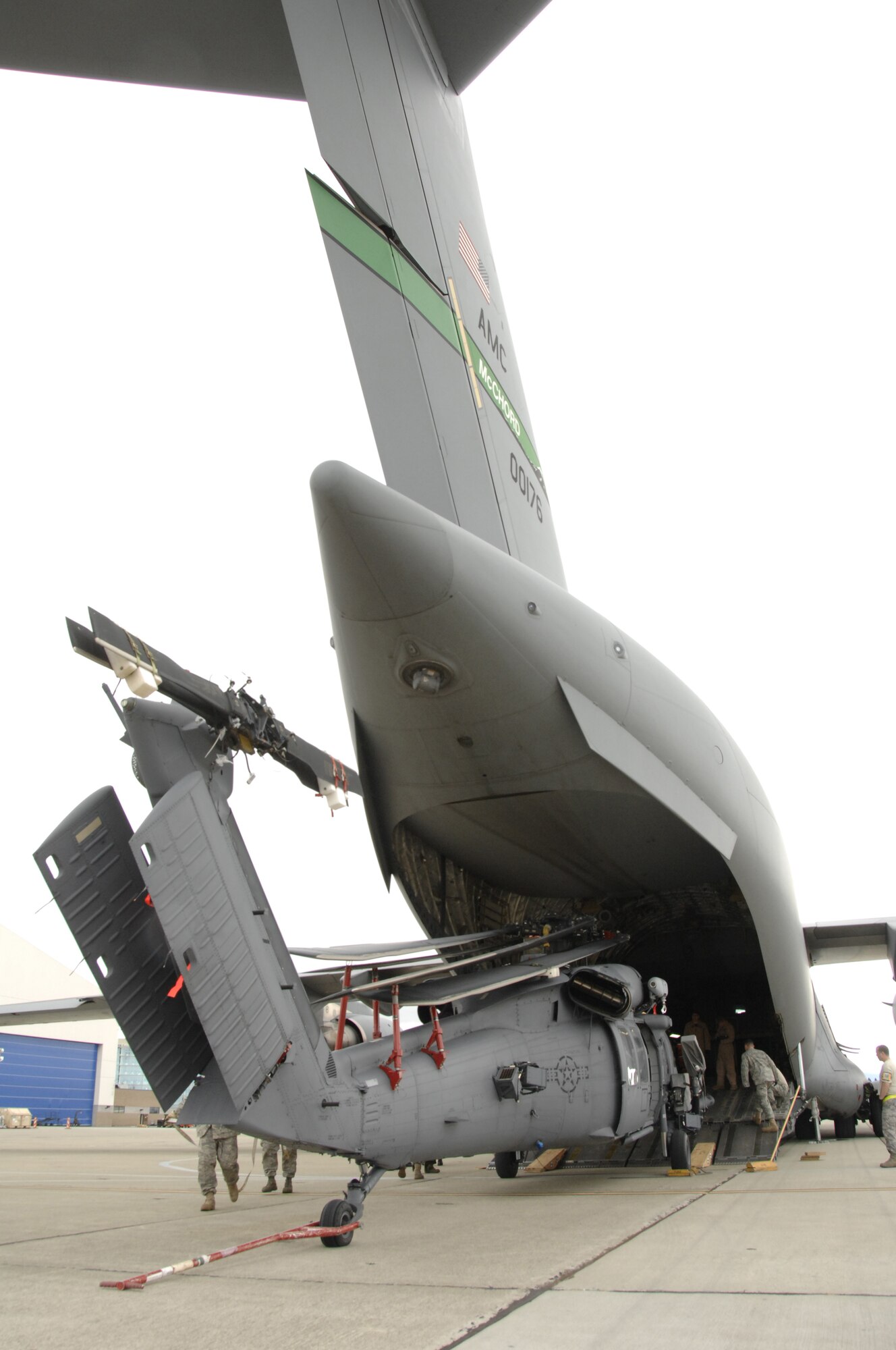 An HH-60G Pave Hawk rescue helicopter from the 129th Rescue Wing, Moffett Federal Airfield, Calif., is prepped for loading in a C-17 Globemaster.  More than 50 Airmen and three Pave Hawks from the 129th Rescue Wing deployed to Afghanistan May 3, 2009. (U.S. Air Force photo by Master Sgt. Dan Kacir)