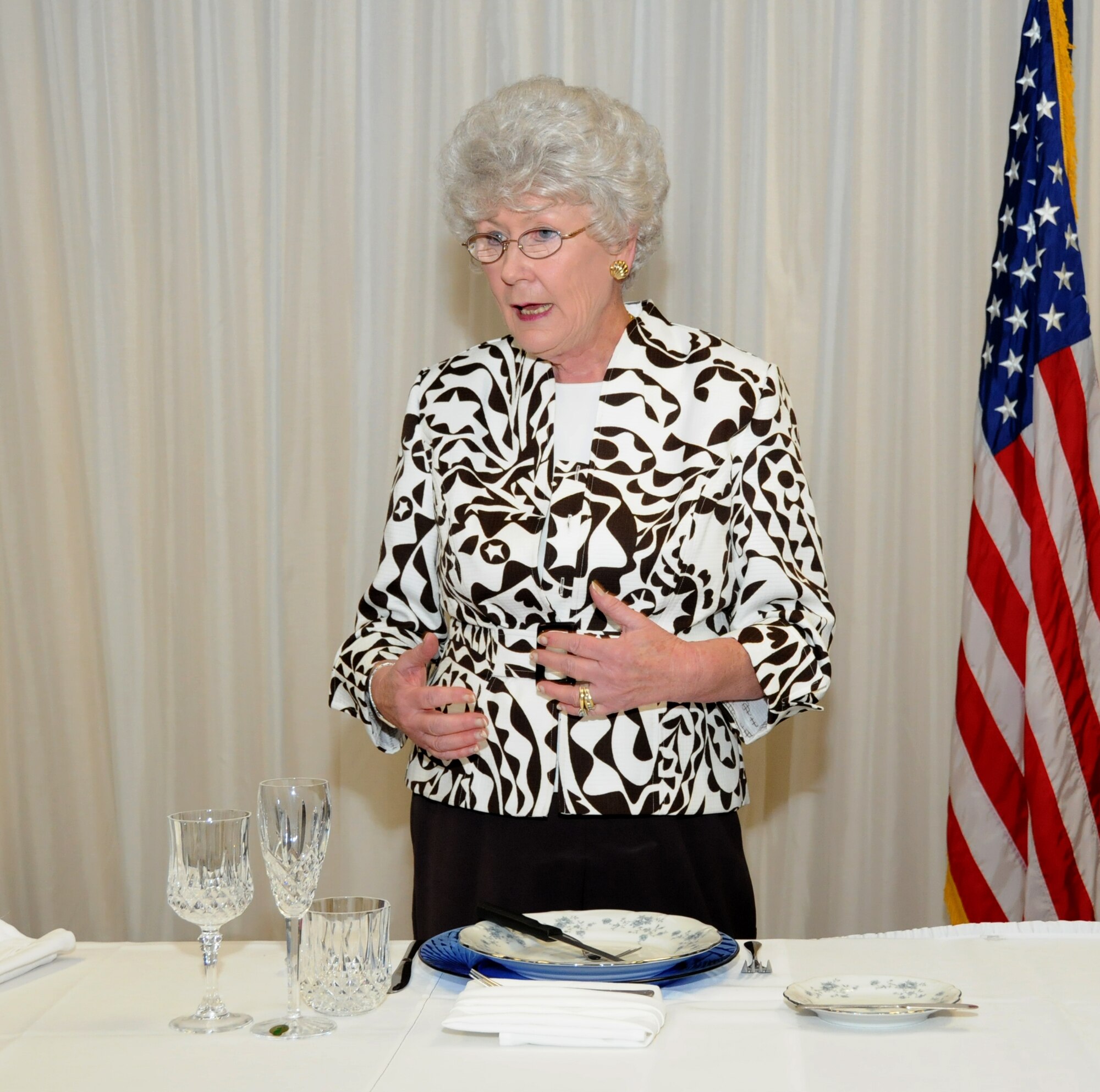 Mrs. Maggie Bonner, Air Force Services Agency, explains the position of fork and knife on a dinner plate and the origins from which they came during a two-day protocol seminar May 5. Mrs. Bonner is the Air Forces protocol authority and provides protocol guidance, management and oversight for executive and senior leadership events throughout the Air Force. During the two days members who attended learned numerous topics to include the importance of a professional image, basic communications and event planning. (U.S. Air Force photo by Senior Airman Eric Summers) 