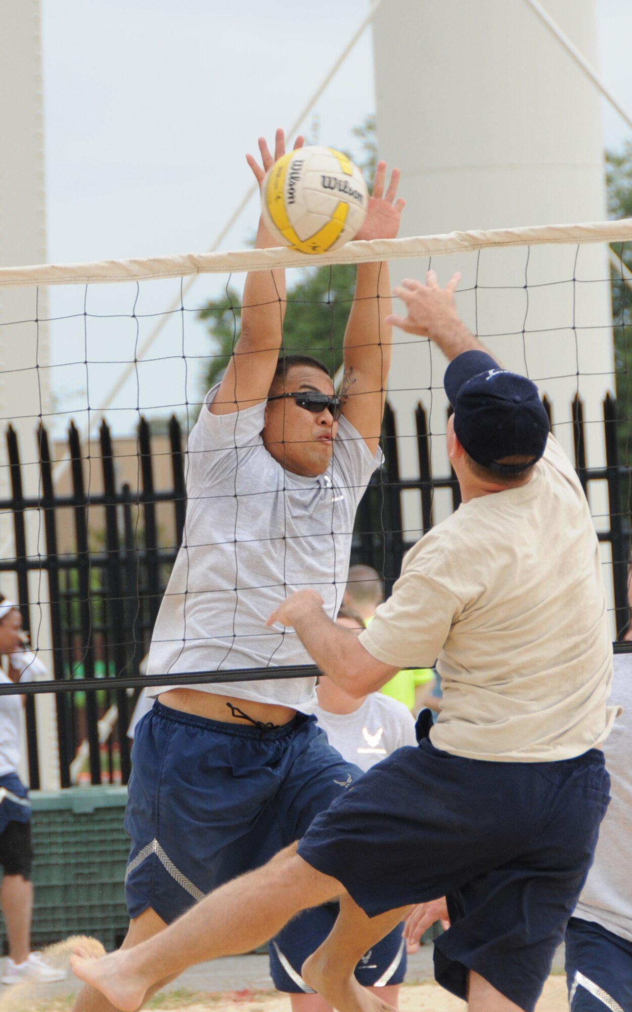 Left, Henry Kabiling, 81st Medical Support Squadron, attempts to block a spike made by Scott Soloman, 333rd Training Squadron, during a volleyball match on Sports Day, April 30.  The 333rd TRS won the volleyball competition.  (U.S. Air Force photo by Kemberly Groue)