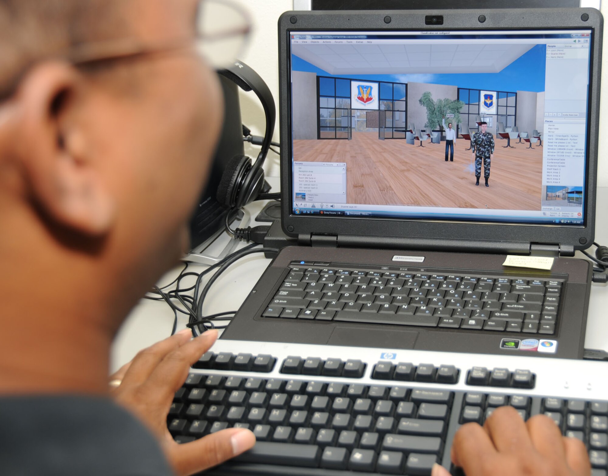 Doug Lee, 81st Training Support Squadron, edits functions to develop the different virtual training environments called forums for the MyBase training and education prototype being developed at Keesler.  The Qwaq software allows the virtual environment to be changed — for instance, the avatar representing  the instructor can be in uniform or civilian clothes, male or female, along with a variety of physical characteristics.  (U.S. Air Force photo by Kemberly Groue)