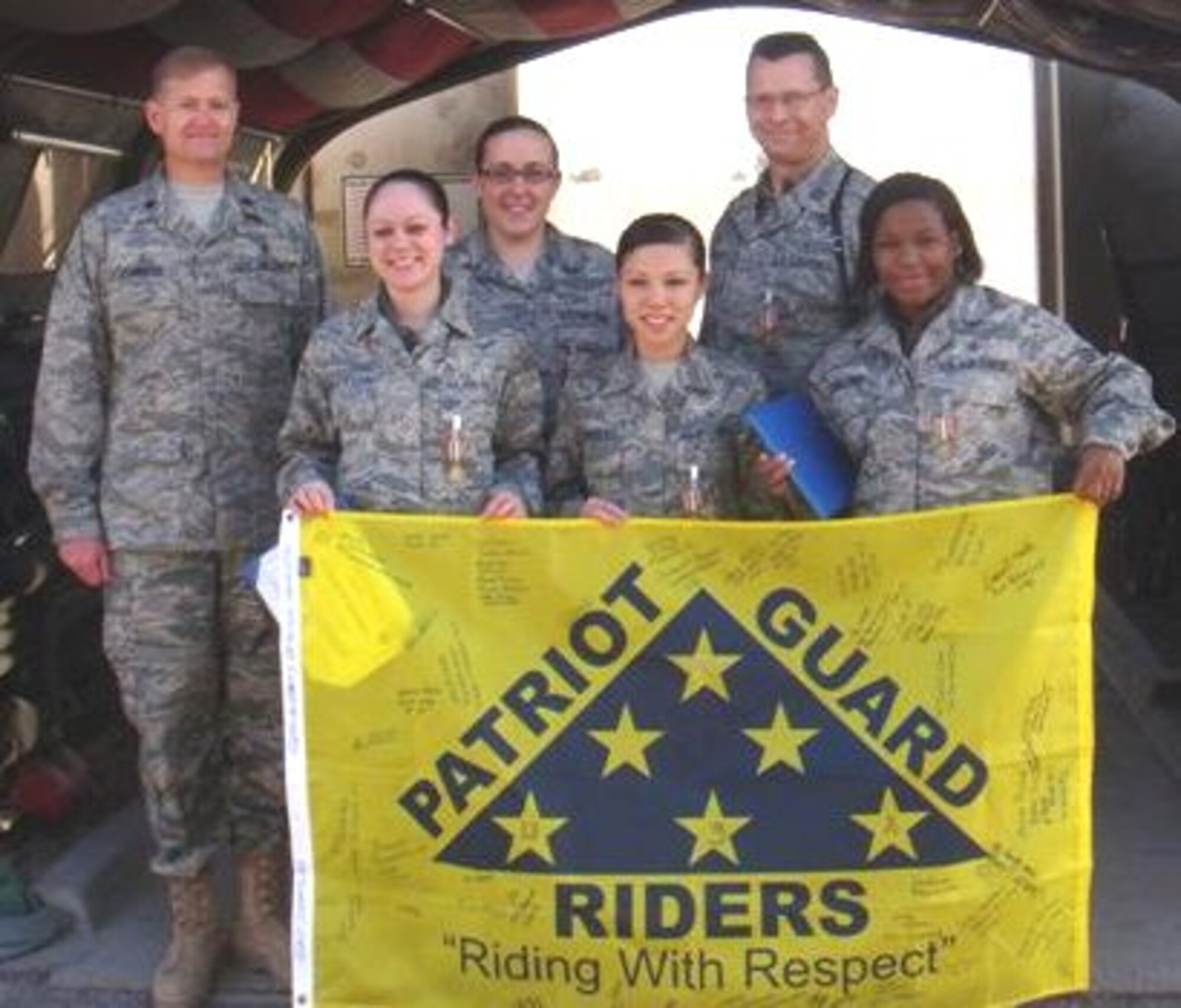 From left, Colonel Johnson, Sergeants  Dirickson and Prickett, Airman Rivera, Captain Curtis and Sergeant Collins display a flag signed by fellow deployers at Balad.  Captain Curtis rides with the Patriot Guard Riders and brought the flag to Iraq.  The riders, mostly motorcyclists, provide respect to fallen service members and send their flags into war zones to show appreciation to the troops.  (Courtesy photo)
