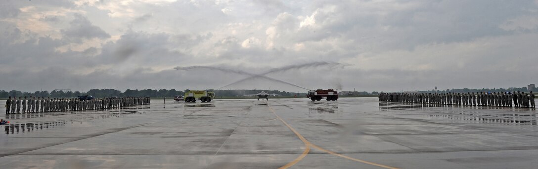 LANGLEY AIR FORCE BASE, Va. -- Brig. Gen. Mark A. Barrett, 1st Fighter Wing commander, taxis his F-22A Raptor between two fire trucks as part of his final flight May 6.  This is General Barrett's last flight as the 1st Fighter Wing commander.  (U.S. Air Force photo/Airman 1st Class Zachary Wolf)

