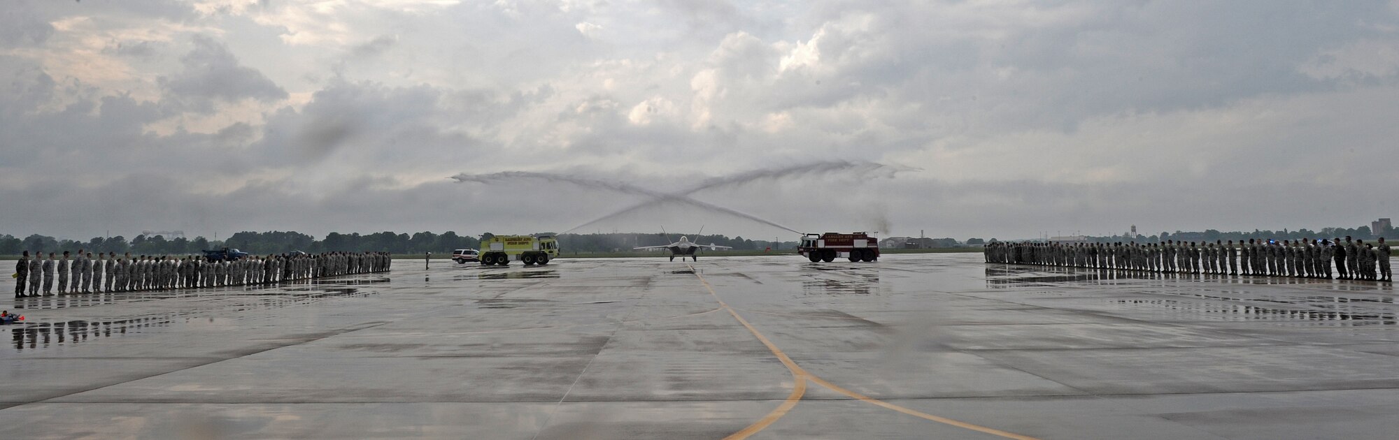 LANGLEY AIR FORCE BASE, Va. -- Brig. Gen. Mark A. Barrett, 1st Fighter Wing commander, taxis his F-22A Raptor between two fire trucks as part of his final flight May 6.  This is General Barrett's last flight as the 1st Fighter Wing commander.  (U.S. Air Force photo/Airman 1st Class Zachary Wolf)
