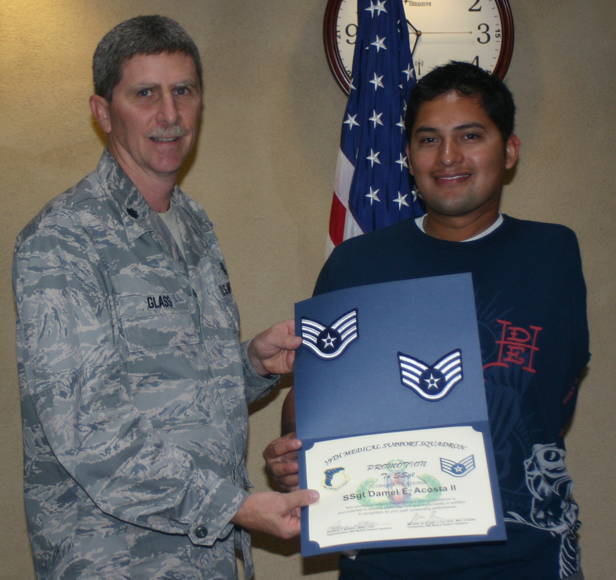 Lt. Col. Michael Glass, 59th Medical Support Squadron commander (left), presents a certificate of promotion to Staff Sgt. Daniel Acosta May 7 at Wilford Hall Medical Center.  Sergeant Acosta, an Air Force wounded warrior, received a surprise promotion to Staff Sergeant, effective Nov. 1, 2008.  (U.S. Air Force photo/Sue Campbell)