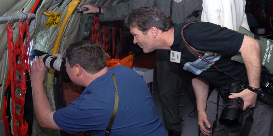 Eric Hughes and John Hilenborough photograph an F-15E Strike Eagle through the window of a KC-135 aircraft from the 916th Air Refueling Wing April 20, 2009. The photographers participated in a media day, where local journalists, photographers and broadcasters were invited to view the aerial capabilities of both the 916th ARW and the 4th Fighter Wing while on a refueling mission over eastern North Carolina. Media flights aid the general public in understanding the Air Force mission and how tax dollars are spent. (U.S. Air Force photo by Airman 1st Class Marissa Tucker)