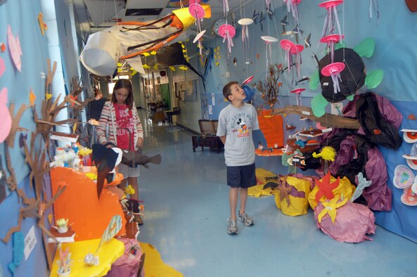 Kelsey Badgett and Connor LaBarge, Robins Elementary 6th grade students, walk through the underwater display on their hallway. U. S. Air Force photo by Sue Sapp 