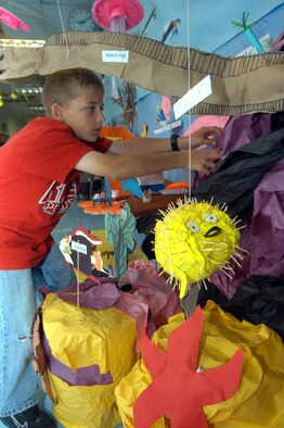 Drew Schuler, Robins Elementary 6th grade student, worked on the coral reef of the underwater display that shows a reef and the interactions of plants and animals on the reef. U. S. Air Force photo by Sue Sapp  