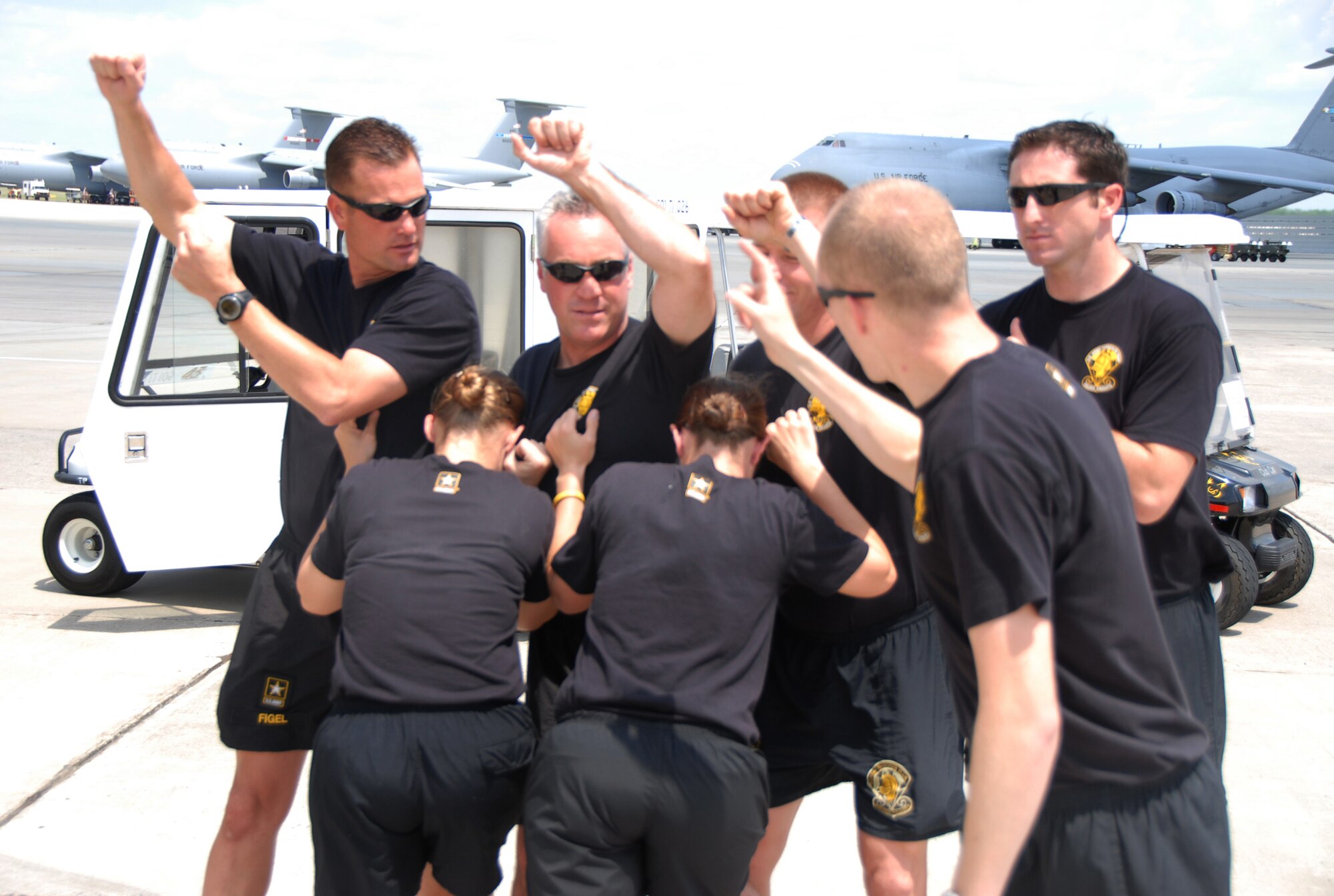 Members of the Golden Knights go through a practice or "dirt dive" on the ground before boarding their aircraft. U. S. Air Force photo by Wayne Crenshaw