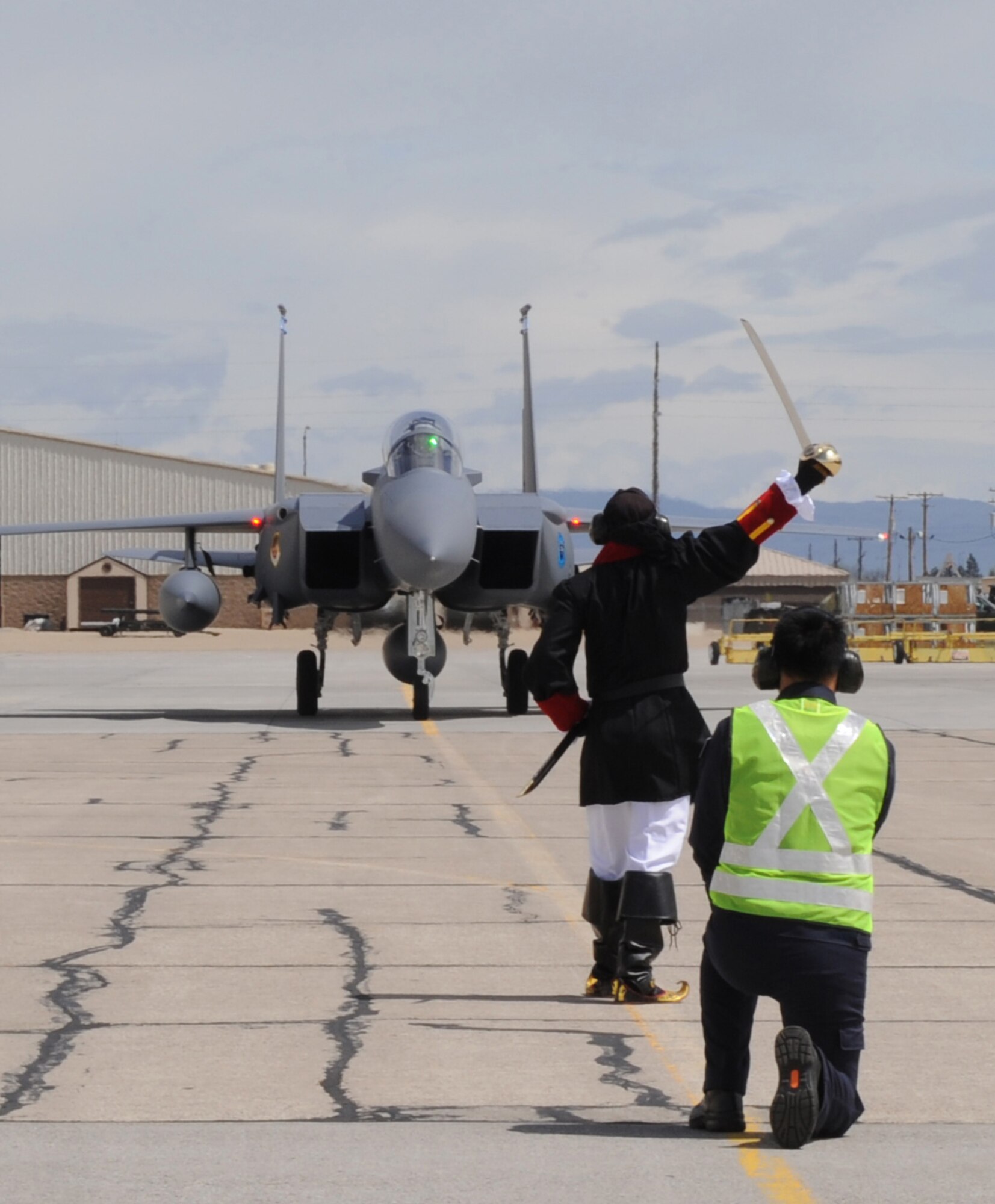 MOUNTAIN HOME AIR FORCE BASE, Idaho - The 428th Fighter Squadron "Buccaneer" mascot poses in front of three F-15SG fighter jets belonging to the Republic of Singapore air force May 6. During a ceremony May 18, the 366th Fighter Wing, in conjunction with the Republic of Singapore air force, will officially activate the 428th Fighter Squadron “Buccaneers” here. The unit will include approximately 180 active duty and 130 support personnel as part of a long-standing partnership with the United States to train its aircrews. Over the life of the program, as many as 2,000 active duty RSAF personnel will live and work on the base. (U.S. Air Force photo/ Airman 1st Class Renishia Richardson)