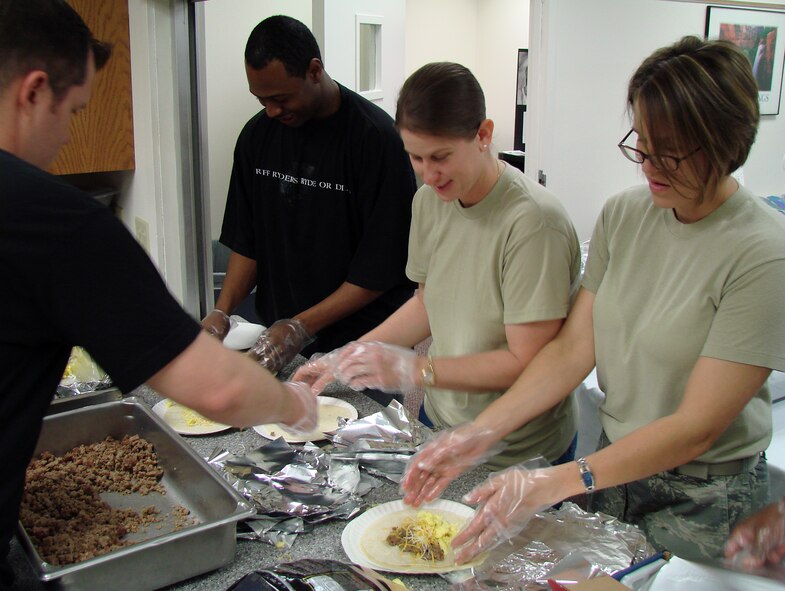 Members of Vance’s Focus 5/6 prepare more than 100 breakfast burritos for the Vance Chapel’s celebration of the 58th annual National Day of Prayer. From left to right are Staff Sgt. James Anderson, Staff Sgt. Omar Robinson, Tech. Sgt. Debra Reddecliff and Tech. Sgt. Laura Rosenzweig. (U.S. Air Force photo/Joe B. Wiles)