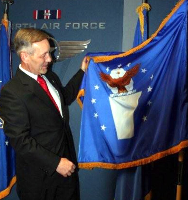 Brig. Gen. Eric W. Crabtree, 4th Air Force Commander, shows the Senior Executive Service flag to his staff following an SES ceremony here on April 30th.  General Crabtree was presented a SES lapel pin after taking the oath of office.  His predecessor, Maj. Gen. Robert E. Duignan (Ret.) administered the oath..  (U.S. Air Force photo/2Lt. Zachary L. Anderson) 