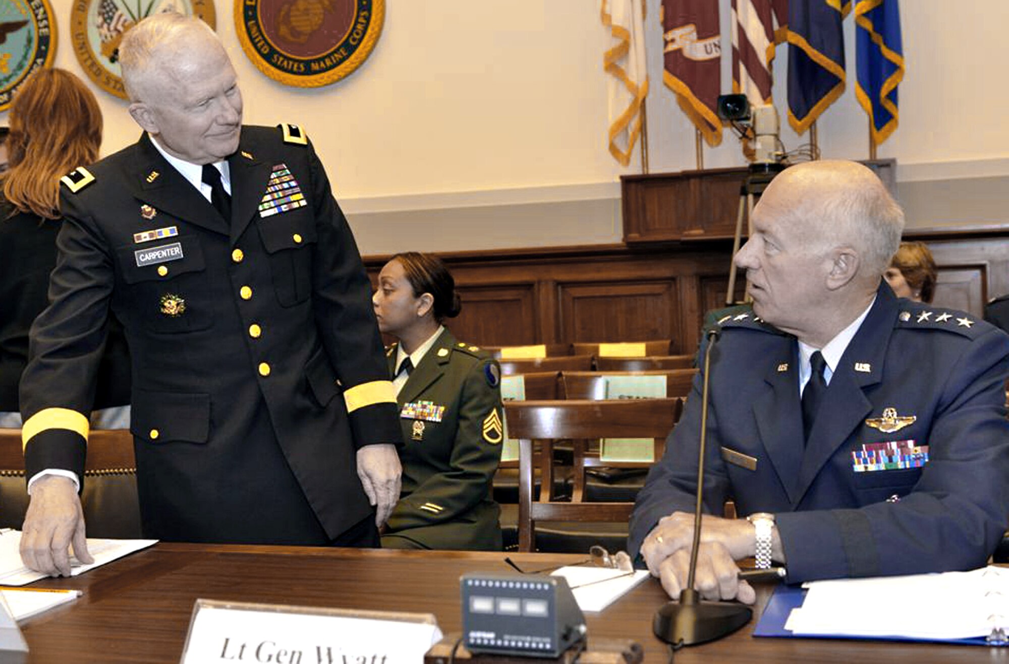 Army Maj. Gen. Raymond W. Carpenter and Lt. Gen. Harry M. Wyatt III prepare to testify before the House Armed Services Committee's air and land forces subcommittee May 5 in Washington, D.C. General Carpenter is the acting deputy director of the Army National Guard, and General Wyatt is the director of the Air National Guard. (U.S. Army photo/Staff Sgt. Jim Greenhill) 
