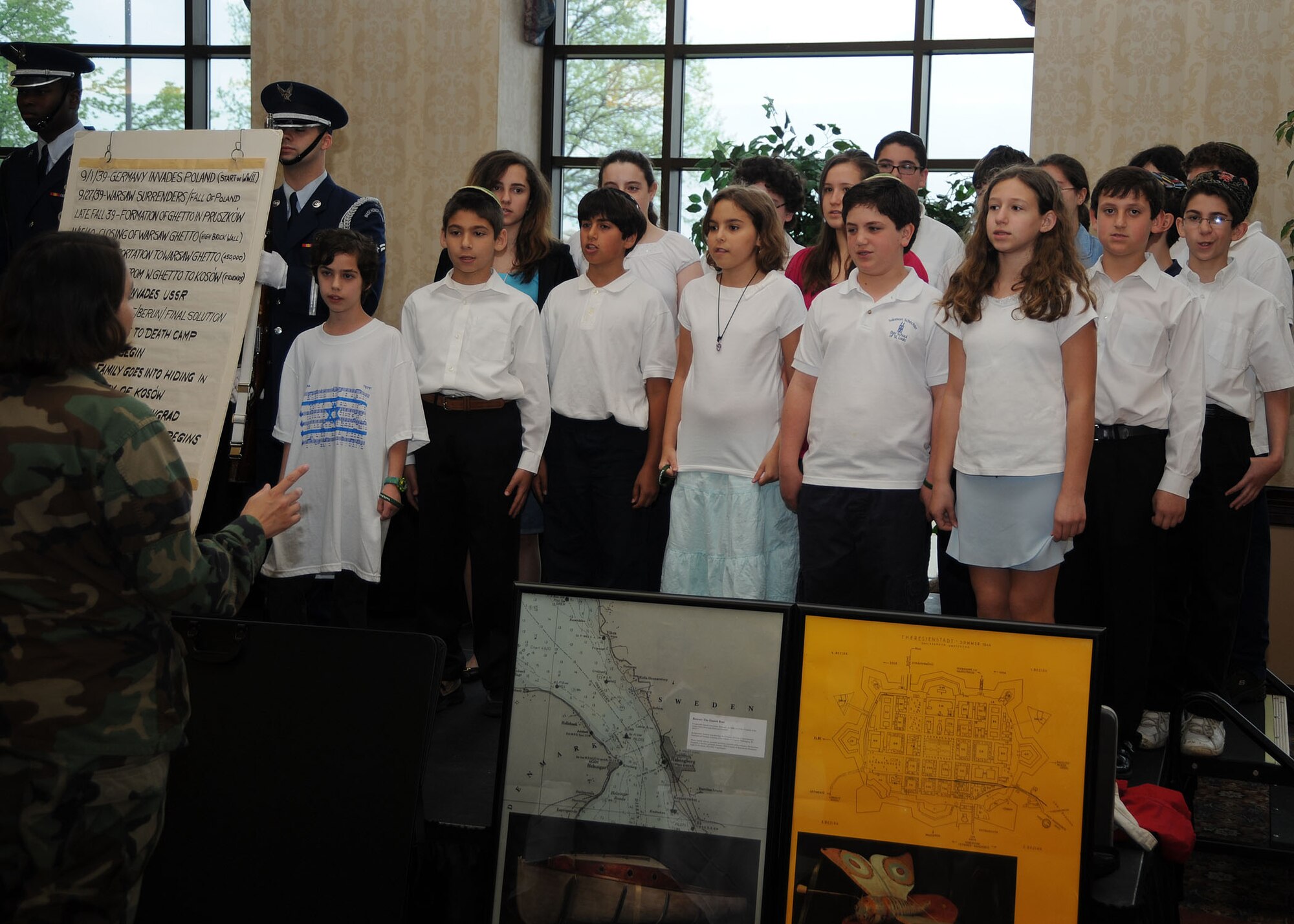 SCOTT AIR FORCE BASE, Ill. -- Children from The Solomon Shecter Day School of St. Louis sing the National Anthem at the start of the Holocaust Remembrance breakfast inside the Scott Club April 30. At the breakfast, members of Team Scott ate a kosher meal while listening to the stories and personal experiences told by Holocaust survivors Jerry Koenig and Fred Ashner. (U.S. Air Force photo/Airman 1st Class Wesley Farnsworth)