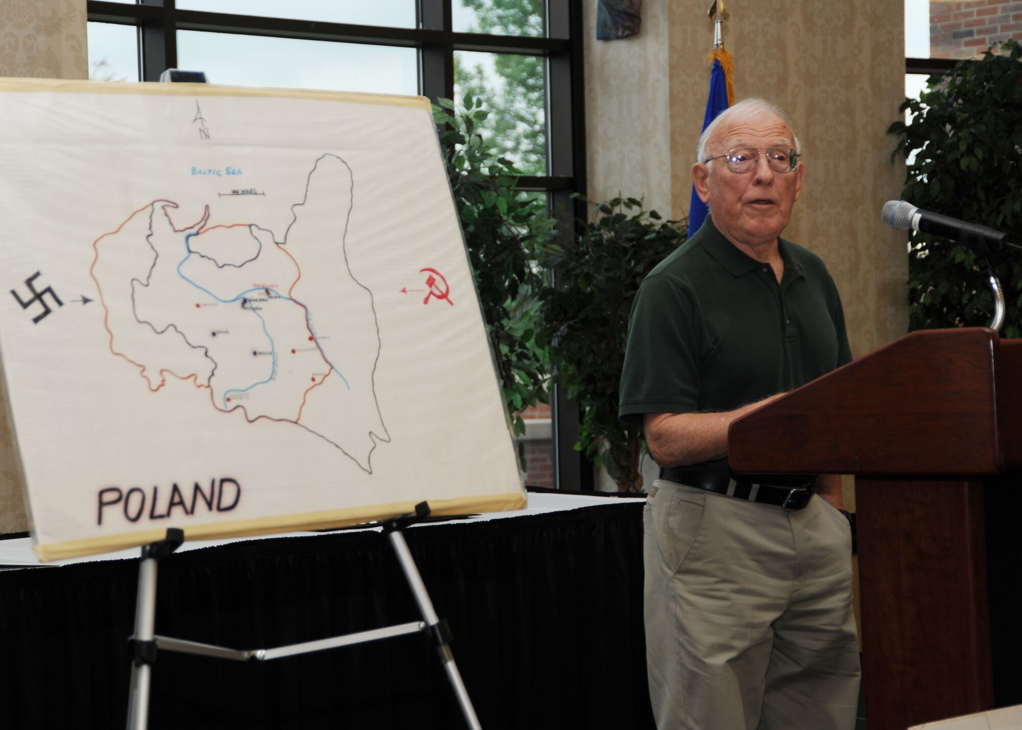 SCOTT AIR FORCE BASE, Ill. -- Holocaust survivor Jerry Koenig speaks to members of Team Scott about his experiences from the Warsaw Ghetto when he was growing up. Mr. Koenig was a guest speaker at the Holocaust Remembrance breakfast inside the Scott Club April 30, where members of Team Scott ate a kosher breakfast while listening to the stories of Mr. Koenig and other guest speaker Fred Ashner. (U.S. Air Force photo/Airman 1st Class Wesley Farnsworth)