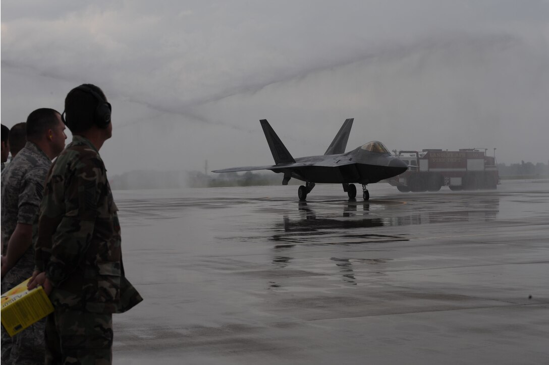 LANGLEY AIR FORCE BASE, Va. -- Brig. Gen. Mark A. Barrett, 1st Fighter Wing commander, gets hosed by the base fire department while taxing in an F-22 Raptor during his final flight here May 6. A fini flight is a old military aviation tradition celebrated by aircrews taking their last flight with their unit. (U.S. Air Force photo/Senior Airman Ashley Hawkins)