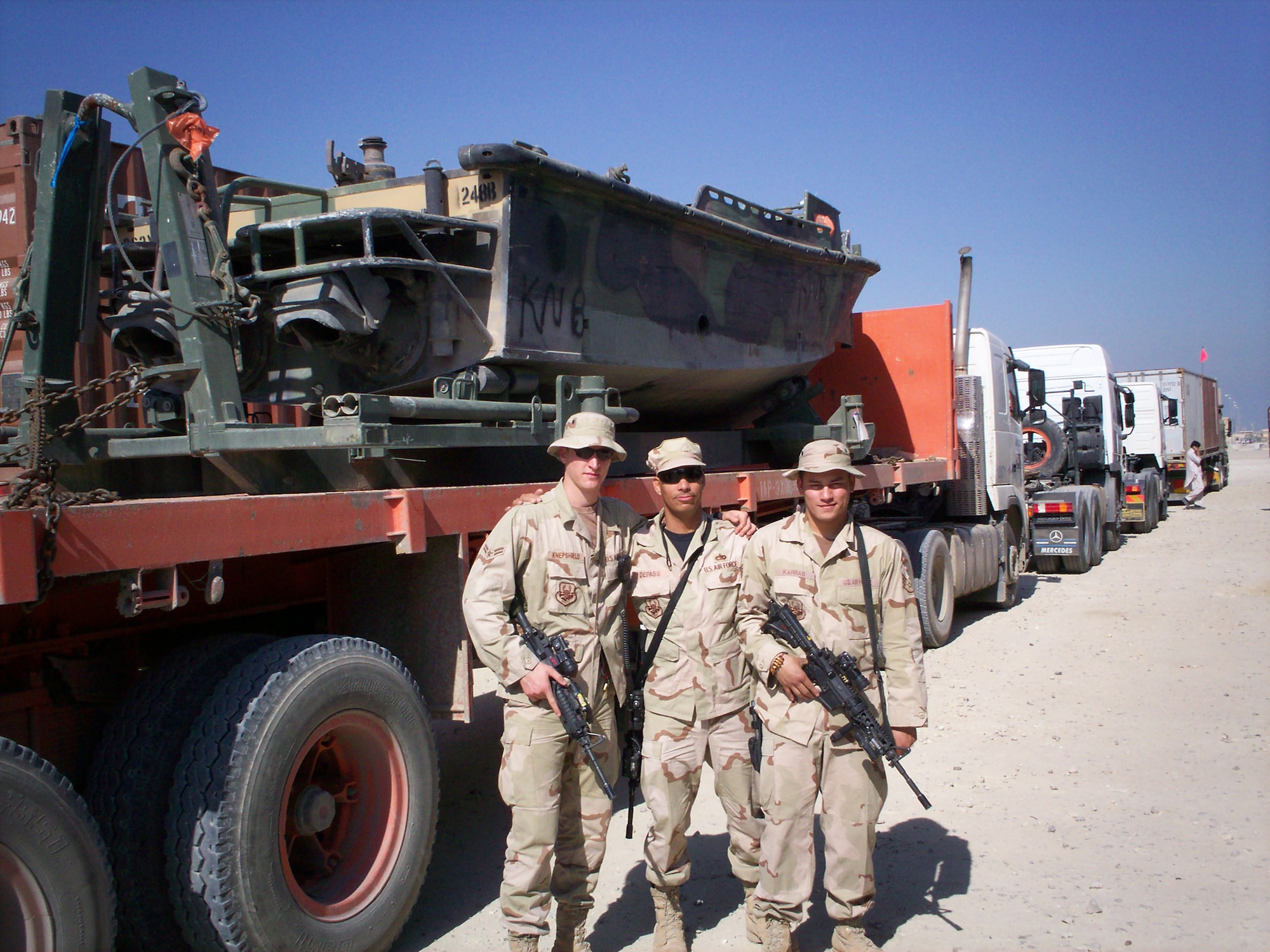 (Left to right) Staff Sgt. Alex Karras, Tech. Sgt. Clarence Depass and Airman 1st Class Talbert Knepshield, 586th Expeditionary Logistics Readiness Squadron, provide convoy support in Southwest Asia.  Members of the 436th LRS commonly deploy to support the only Air Force ground cargo transportation mission into Iraq.  (U.S. Air Force photo/courtesy photo)