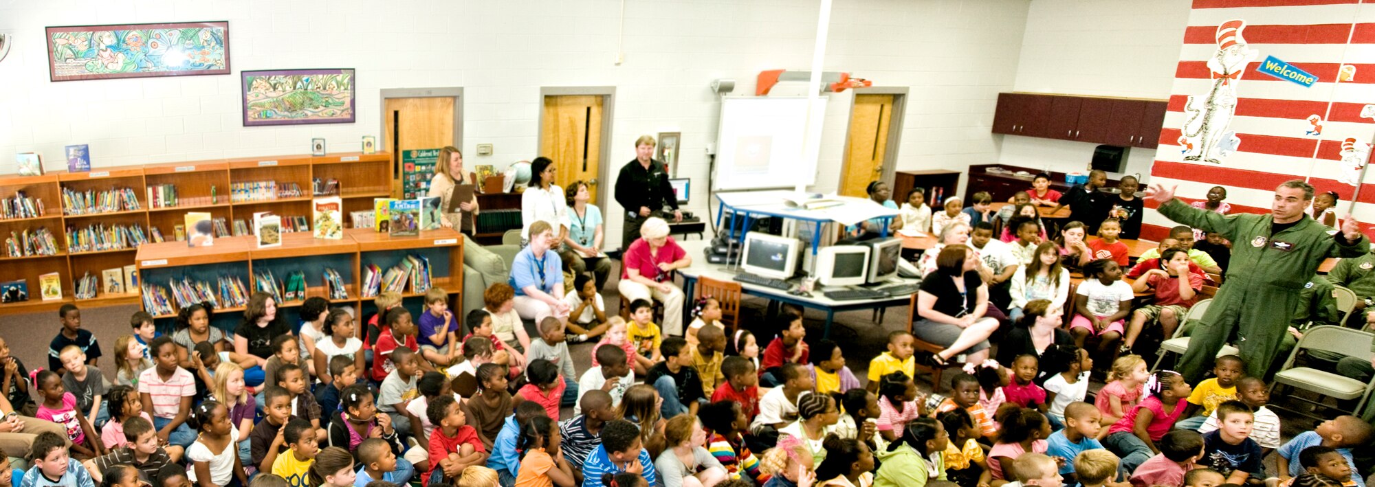 Lt. Col. John Fox, pilot, 53rd WRS, shares a few quick stories about what it's like flying through hurricanes as a hurricane hunter. Colonel Fox and other Citizen Airmen from the Hurricane Hunters and Flying Jennies squadrons of the 403rd Wing visited Pass Road Elementary school to autograph a mural painted in the library in their honor. 