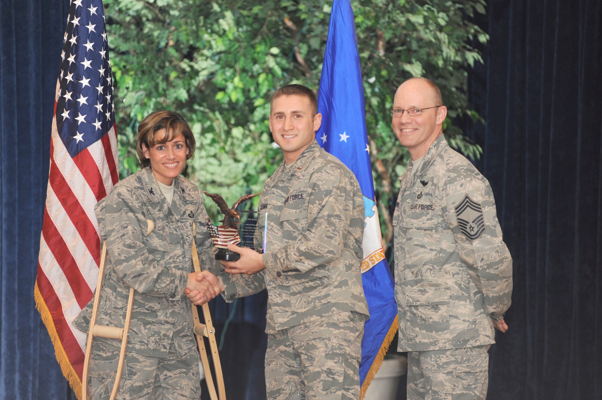 2nd Lieutenant Jared Kleiman of the 87th Logistics Readiness Squadron receives the Company Grade Officer of the Quarter award from Col. Gina Grosso, 87th ABW commander, and Chief Master Sgt. Warren Wofford, acting command chief for the 87th ABW. (U.S. Air Force photo/Carlos Cintron)

