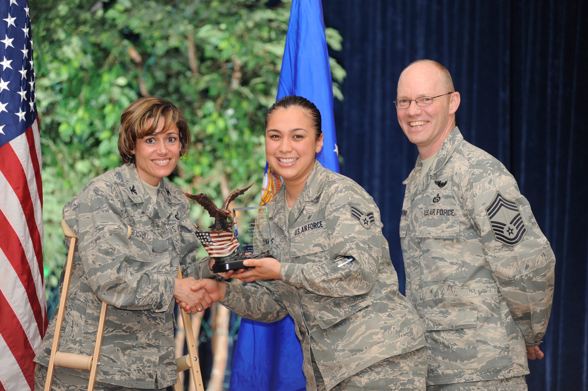 Senior Airman Yessenia Davis, center, of the 87th Medical Support Squadron is presented with the Airman of the Quarter award by 87th ABW Commander Col. Gina Grosso and Chief Master Sgt. Warren Wofford, acting command chief for the 87th ABW. (U.S. Air Force photo/Carlos Cintron)