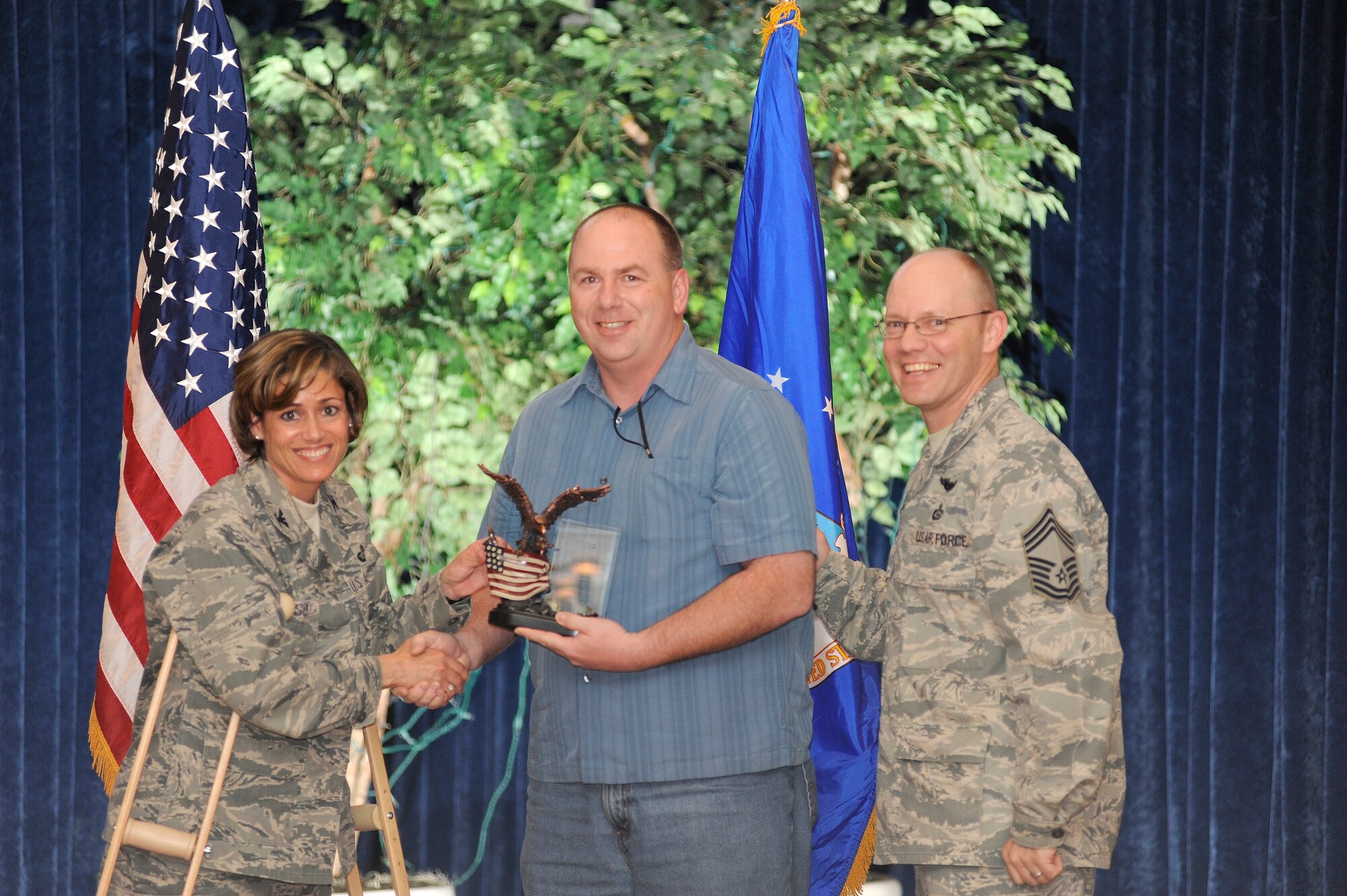 Assisted by Acting Command Chief Warren Wofford, 87th Air Base Wing Commander Col. Gina Grosso presents the Civilian of the Quarter Category 2 award to Mr. Edward Smith of the 87th Logistics Readiness Squadron. The quarterly awards recognize Airmen, both civiilan and military, for their professional accomplishments. (U.S. Air Force photo/Carlos Cintron)
