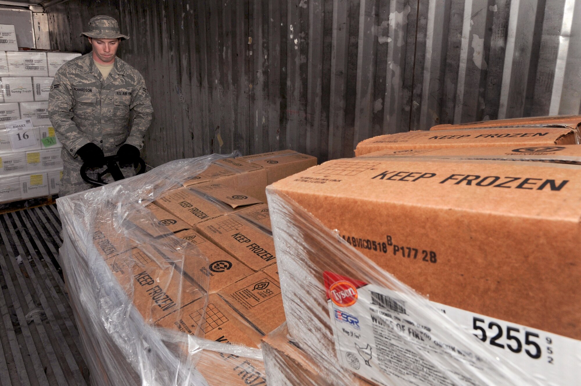 Airman 1st Class Martin Richardson, a rations clerk with the 379th Expeditionary Force Support Squadron, reorganizes a cold storage container to free up additional space, May 6, 2009, in an undisclosed location in Southwest Asia.  Each storage container is organized by different types of food, making it easier to locate and retrieve items as needed. Airman Richardson is native to Conway, Ark., and is deployed from Little Rock Air Force Base, Ark. in support of Operations Iraqi and Enduring Freedom and Combined Joint Task Force - Horn of Africa.  (U.S. Air Force Photo by Staff Sgt. Joshua Garcia/released)