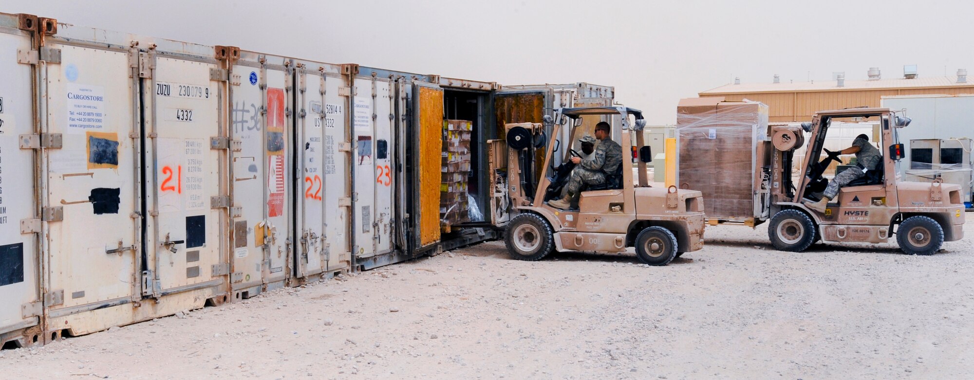 Senior Airman Leandro Corchado, and Senior Airman Daniel Bickford, both rations clerks with the 379th Expeditionary Force Support Squadron, load pallets of fresh frozen foods into cold storage containers, May 6, 2009, in an undisclosed location in Southwest Asia.  The rations shop places the food order, receives the food, stores the food, and finally distributes to each dining facility the required amount of food for their daily consumption.  Airman Corchado hails from Miami, Fla. and Airman Bickford is native to Lafargeville, N.Y., both are deployed from Nellis Air Force Base, Nev., in support of Operations Iraqi and Enduring Freedom and Combined Joint Task Force - Horn of Africa.  (U.S. Air Force Photo by Staff Sgt. Joshua Garcia/released)