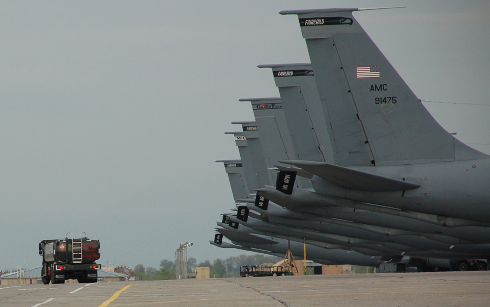 An R-11 refueler truck passes by a line of KC-135 Stratotankers on the flightline at Manas Air Base, Kyrgyzstan, May 2. Every day, the 376th Expeditionary Logistics Readiness Fuels Management Flight pumps out between 200,000 to 350,000 gallons to keep missions flying in support of Operation Enduring Freedom in Afghanistan. One R-11 can hold up to 6,000 gallons of TS1 jet fuel. A KC-135 holds about 200,000 gallons of jet fuel that the tanker offloads to a variety of aircraft in the sky over Afghanistan. (U.S. Air Force photo/Tech. Sgt. Phyllis Hanson)