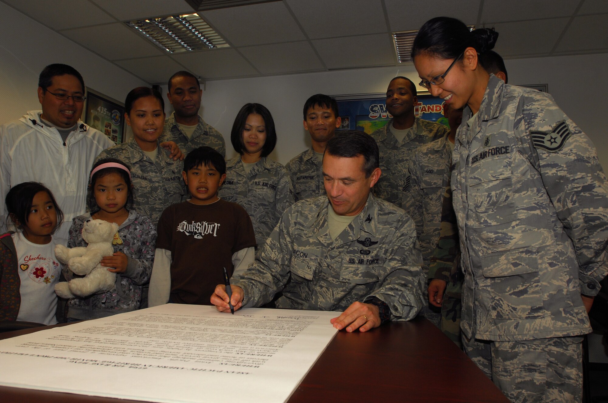 435th Air Base Wing Commander, Col. Don Bacon signs an Asian Pacific Heritage month proclamation, May 5, 2009, Ramstein Air Base, Germany. Asian pacific heritage committee members will be holding a taste of Asia breakfast, May 8, 2009, at the Ramstein Officer's Club. (U.S. Air Force photo by Senior Airman Kenny Holston)