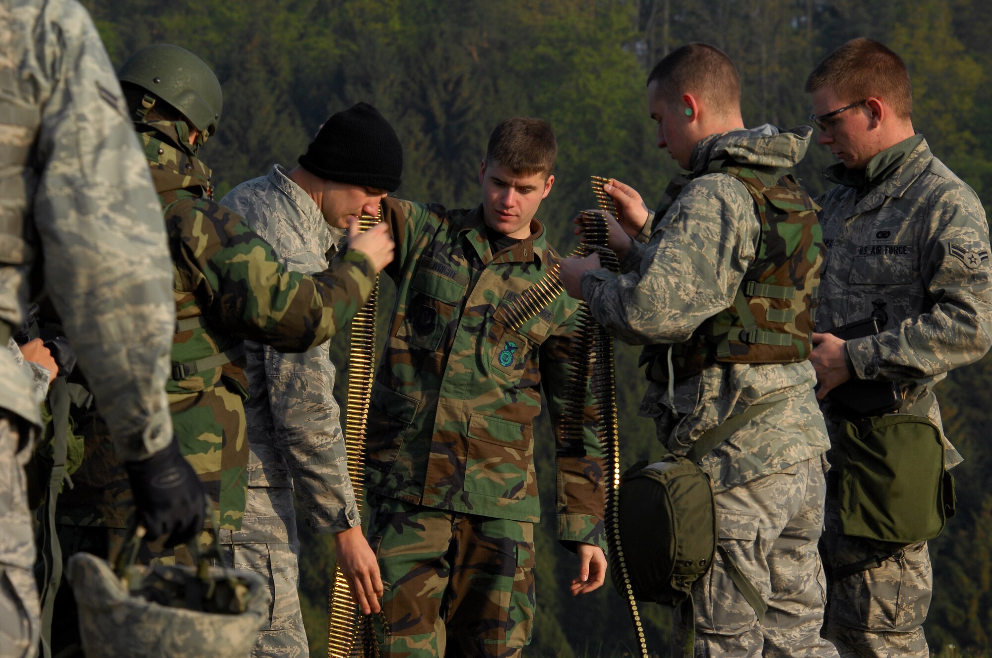 United States Air Force Security Forces Airmen sort M249 squad automatic weapon (SAW) rounds in preparation for weapons training from the 569th United States Forces Police Squadron weapons instructors, April 30, 2009, Baumholder, Germany. The 569th USFPS executes several different missions from installation security to weapons and deployment training. (U.S. Air Force photo by Senior Airman Kenny Holston)