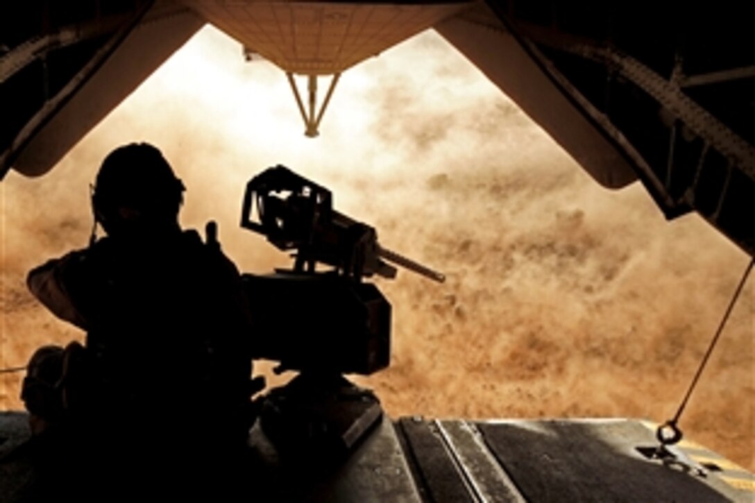 A U.S. Marine sits on the end of a CH-53E helicopter ramp during a training exercise near Camp Lemonier, Djibouti, May 2, 2009. The helicopter provided transportation for a joint tactical team to recover simulated isolated personnel in a austere environment. The Marine is assigned to Marine Heavy Helicopter Squadron 461.