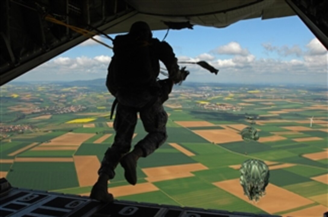 U.S. Air Force and Army paratroopers jump from the tail gate of a C-130J Super Hercules cargo aircraft during its first personnel drop over southern Germany on May 4, 2009.  