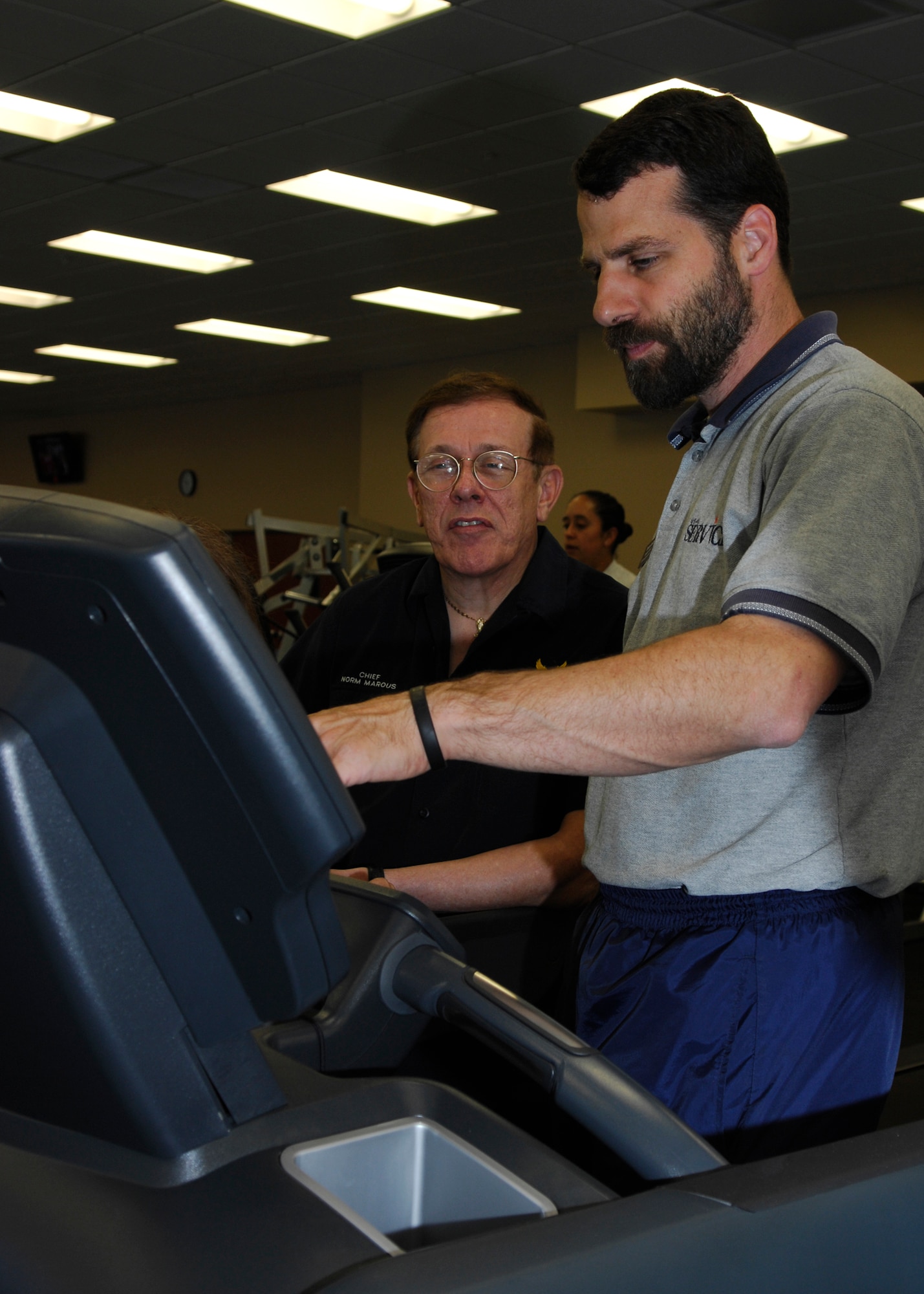 VANDENBERG AIR FORCE BASE, Calif. --  Thomas Anastasio assistant director of the Vandenberg Fitness Center, demonstrates how the new treadmill works to Norm Marous, a retired chief master sergeant, here May 8. Following the ribbon cutting ceremony, customers of the fitness center were given a tour of the new equipment available for use. (U.S. Air Force photo/Airman 1st Class Heather Shaw)