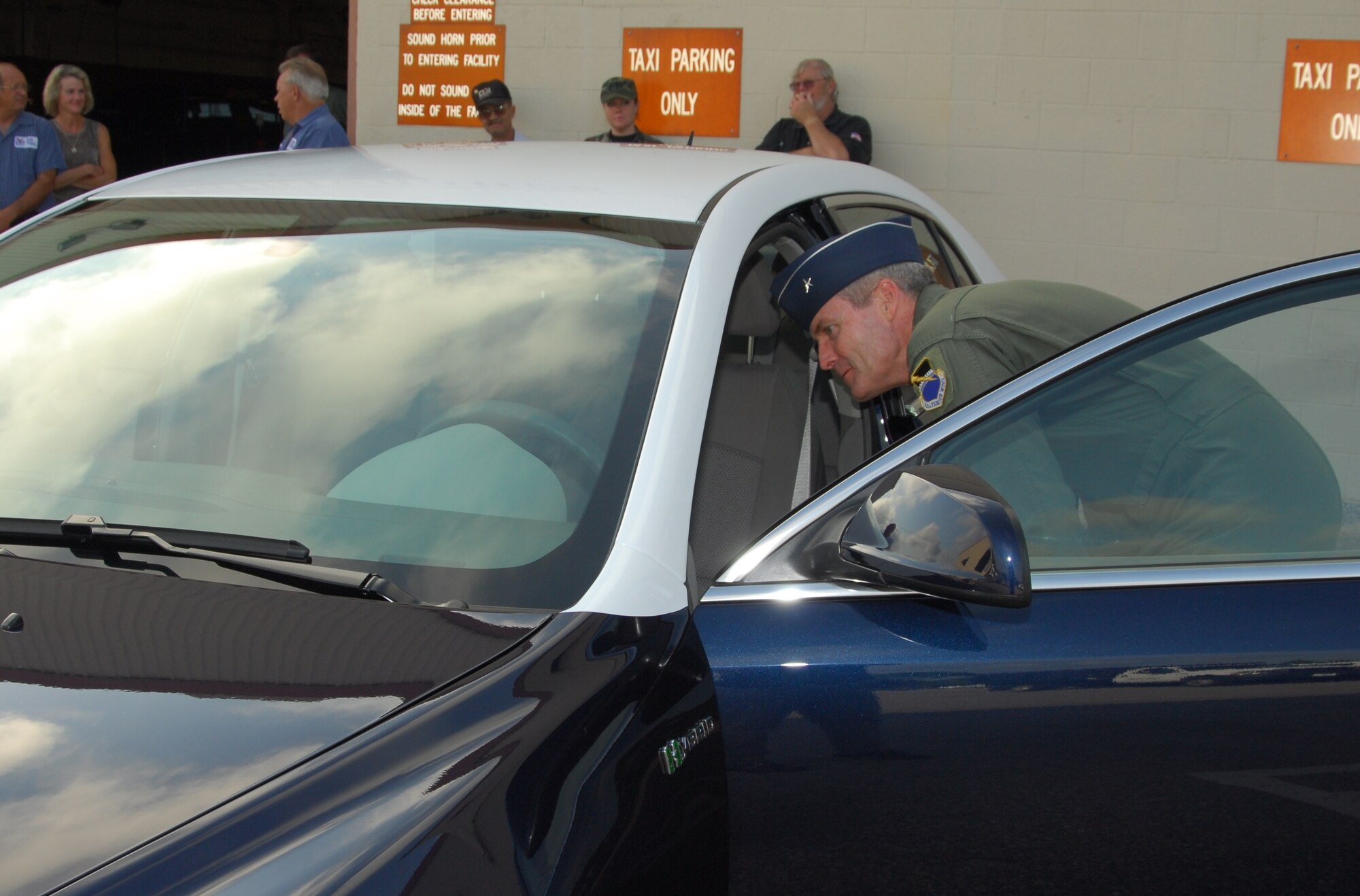 Brig. Gen. Darryl Roberson, 325th Fighter Wing commander, views the inside of his new environment-friendly vehicle May 8 at the Tyndall AFB transportation building.  (U.S. Air Force photo/Lisa Norman)