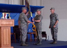 Maj. Gen. Winfield Scott III hands the 437th Airlift Wing guideon to Col. John Wood during the change of command ceremony at Charleston AFB May 8. Colonel Wood assumed command of the 437th AW from Col. John "Red" Millander. General Scott is the 18th Air Force commander. (U.S. Air Force photo/Senior Airman Timothy Taylor)