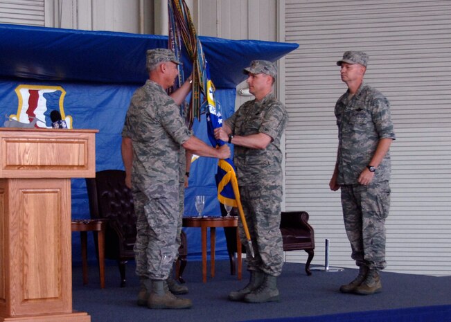 Maj. Gen. Winfield Scott III hands the 437th Airlift Wing guideon to Col. John Wood during change of command ceremony at Charleston Air Force Base May 8. Colonel Wood assumed command of the 437 AW from Col. John "Red" Millander. General Scott III is the 18th Air Force commander. (U.S. Air Force photo/Senior Airman Timothy Taylor)