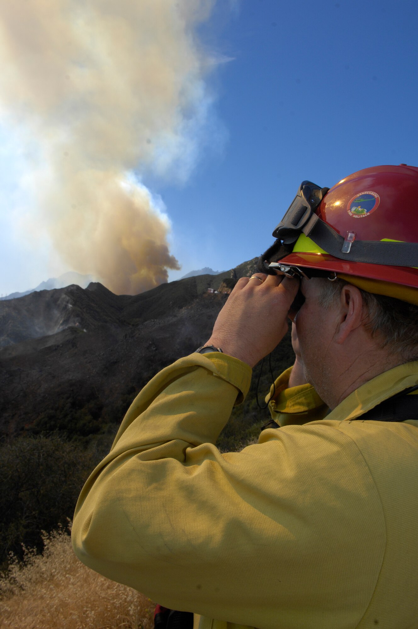 SANTA BARBARA, Calif. -- As flames aproach, John Crotty, a 30th Civil Engineer Squadron fire captain, surveys the line of the Jesusita wildfire here May 7. Vandenberg's fire fighters regularly work with firefighters across the state to put out the flames during California's fire season. (U.S. Air Force photo/Airman 1st Class Andrew Lee)