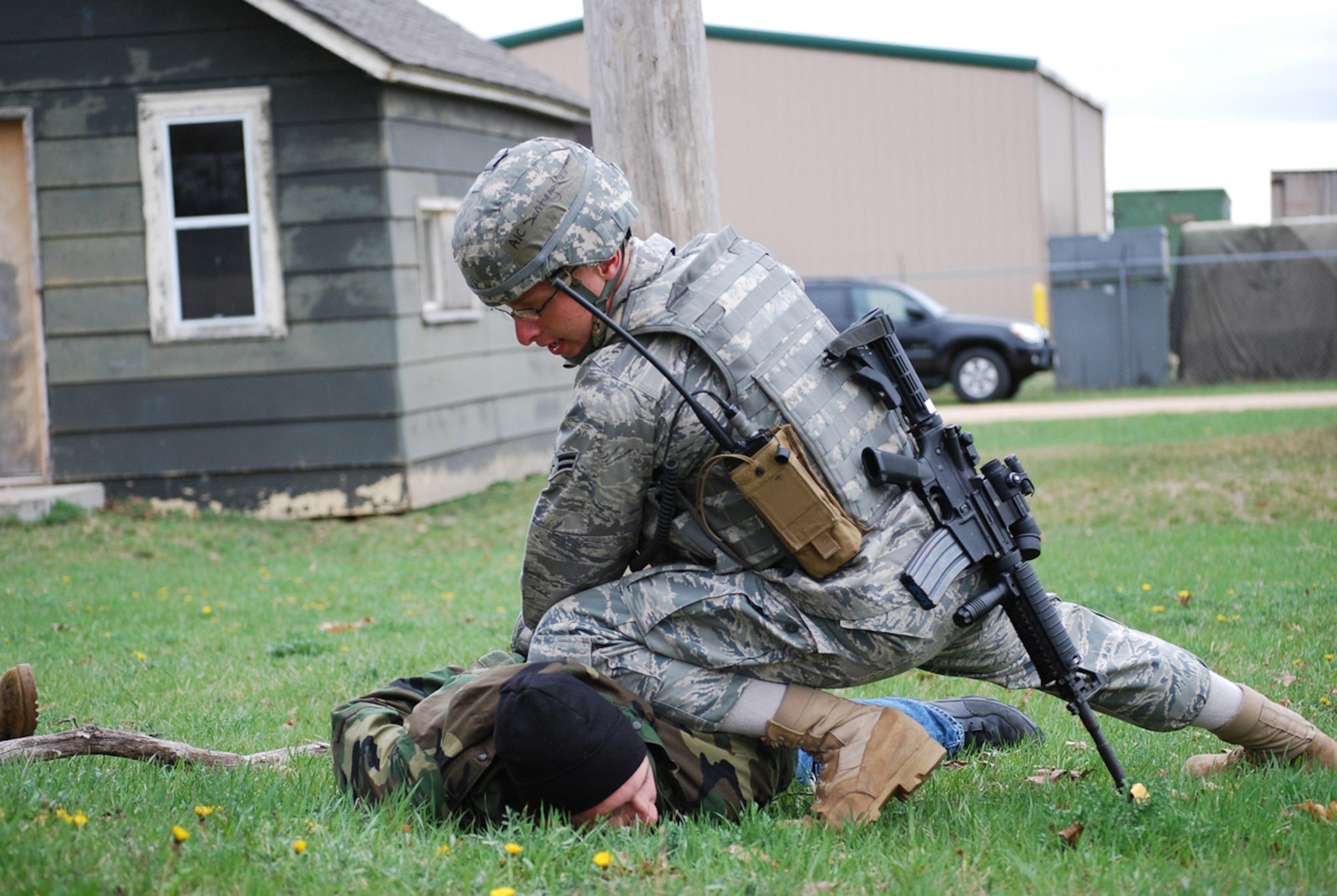 Airman 1st Class Angel Santiago, a security forces Airman from the 816th Contingency Response Group, subdues a detainee during Military Operations on Urban Terrain training at Volk Field, Wisc., April 22-30. The MOUT training was part of the 621st Contingency Response Wing's Operational Readiness Exercise, preparing the wing for next year's inspection. (U.S. Air Force photo/Staff Sgt. Nicholas Phelps)