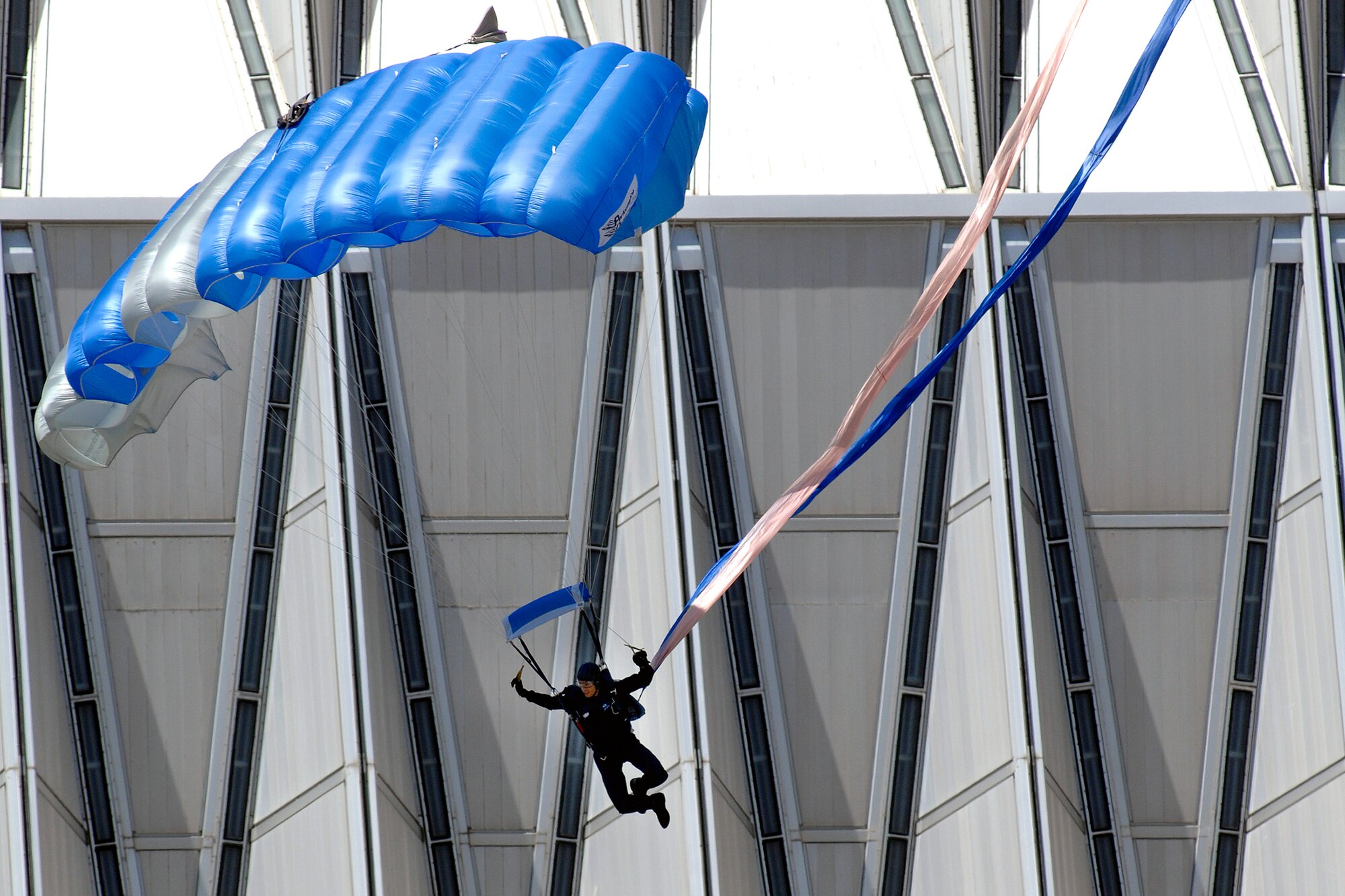 A member of the U.S. Air Force Academy's Wings of Blue Parachute team carefully maneuvers his canopy near the Cadet Chapel toward a successful landing in the Academy's cadet area in Colorado May 6. The team performed a demonstration jump during the afternoon meal formation in front of the entire cadet wing and Academy visitors. (U.S. Air Force photo/Dennis Rogers)