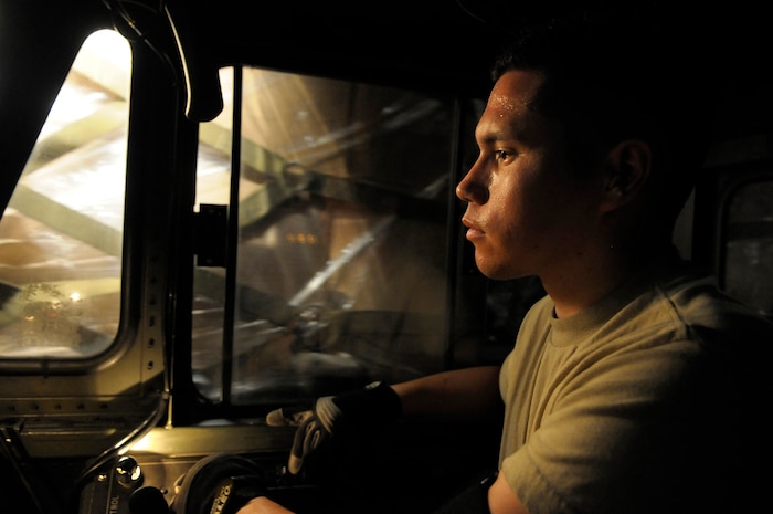 U.S. Air Force Airman Rodrigo Maranon drives a 60K loader with pallets of personal protection kits at Charleston Air Force Base, S.C., May 8, 2009. Thirty thousand personal protection kits were shipped via C-17 to Haiti, El Salvador, Guatemala, Honduras and Nicaragua, where health-care officials are responding to confirmed and suspected cases of H1N1 Influenza-A infections. U.S. Southern Command, headquartered in Miami, directed the mission after learning health officials submitted requests for assistance to U.S. embassies in their respective countries. Airmen Maranon is an air transportation specialist with 437th Aerial Port Squadron at Charleston AFB. (U.S. Air Force photo by James M. Bowman)(RELEASED)