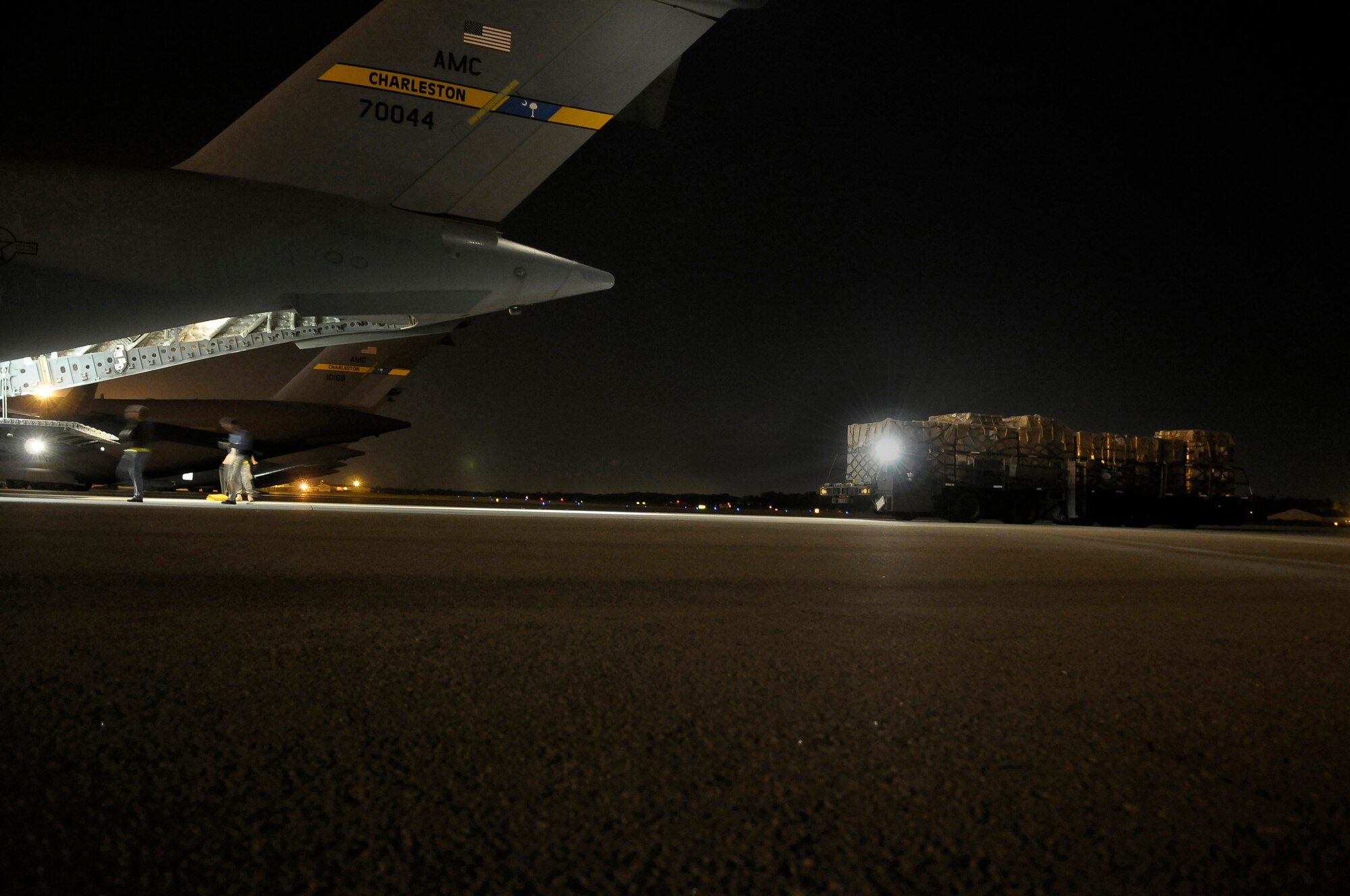 Airman use a 60K loader to transport 30,000 personal protection kits is loaded onto a C-17 at Charleston Air Force Base S.C., May 8, 2009. The pallets of personal protection kits were destined for Haiti, El Salvador, Guatemala, Honduras and Nicaragua, where health-care officials are responding to confirmed and suspected cases of H1N1 Influenza-A infections. U.S. Southern Command, headquartered in Miami, directed the mission after learning health officials submitted requests for assistance to U.S. embassies in their respective countries. (U.S. Air Force photo by James M. Bowman)(RELEASED)