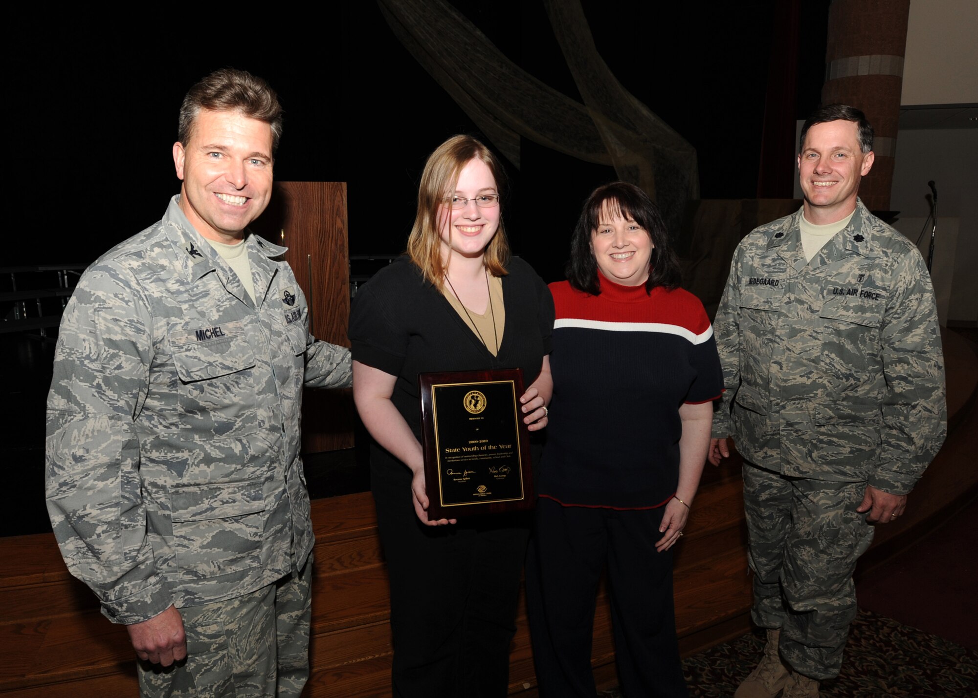Col. John Michel, 319th Air Refueling Wing commander presents Miranda Nedegaard, daughter of Lt. Col. Randall Nedegaard, a plaque for Youth of the Year through the Boys and Girls Club of North Dakota. She will compete in the regional conpetition in Chicago next month.
(U.S. Air Force Photo By Staff Sgt. Suellyn F. Nuckolls)(Released)