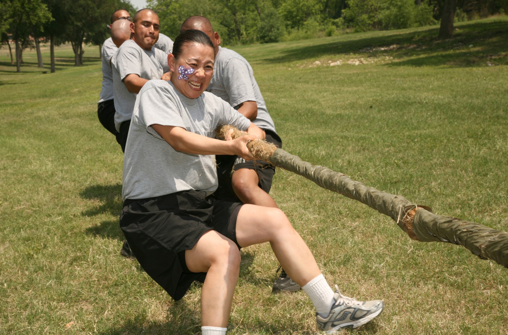 Defense Language Institute students enjoy a game of tug-of-war at the DLI AMIGO picnic May 1 at Stillman Park. The event featured food, music and various activities, including volleyball, tug-of-war and water balloon fights. (U.S. Air Force photo/Robbin Cresswell)  